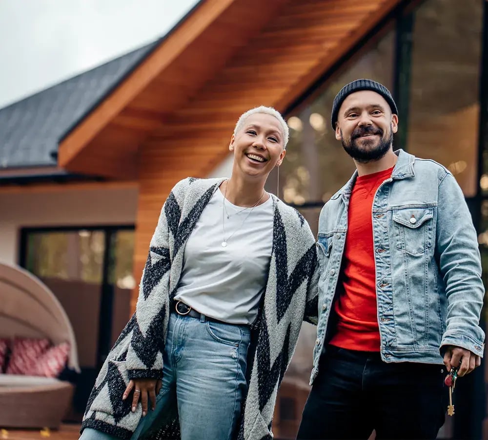Happy couple out back of a large home
